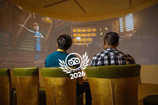 Twee bezoekers volgen een interactieve presentatie met kaasmeester Ralfie bij de Gouda Cheese Experience.